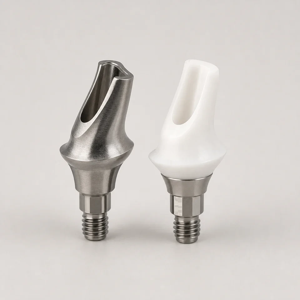 Two custom implant abutments, one titanium and one white ceramic, on a neutral background